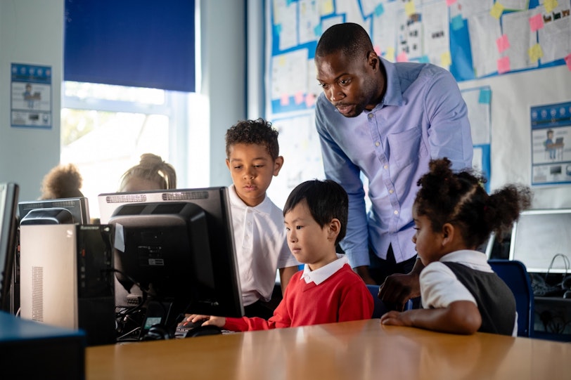 Stock Teacher and students on computers 3 1340023767